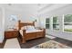A bright main bedroom features dark wood floors, a wooden bed frame, and large windows at 617 Worthington Dr, Winter Park, FL 32789