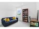 Inviting office space featuring a comfortable blue sofa, a wooden bookshelf, and a bright window at 617 Worthington Dr, Winter Park, FL 32789