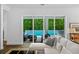 A tranquil patio and pool area framed by lush greenery, seen through sliding glass doors at 617 Worthington Dr, Winter Park, FL 32789