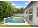 Backyard pool with waterfall feature and spa near an outdoor seating area at 617 Worthington Dr, Winter Park, FL 32789