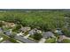 Aerial view of a residential neighborhood featuring lush greenery, ponds, and well-maintained homes at 705 Sunburst Cove Ln, Winter Garden, FL 34787