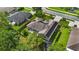 Aerial view of a private backyard with lush green grass, a patio set, and a trampoline at 705 Sunburst Cove Ln, Winter Garden, FL 34787