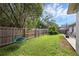 This backyard includes a swing and a fenced in yard at 705 Sunburst Cove Ln, Winter Garden, FL 34787