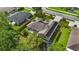 Aerial view of a private backyard with lush green grass, a patio set, and a trampoline at 705 Sunburst Cove Ln, Winter Garden, FL 34787