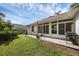 The backyard includes a screened in porch and a grilling area at 705 Sunburst Cove Ln, Winter Garden, FL 34787