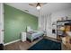 Bedroom features stylish decor, a ceiling fan, and hardwood floors at 705 Sunburst Cove Ln, Winter Garden, FL 34787