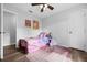 Bright bedroom features hardwood floors, ceiling fan, and a pink rug at 705 Sunburst Cove Ln, Winter Garden, FL 34787