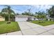 Landscaped home with a two-car garage, long driveway and well manicured lawn at 705 Sunburst Cove Ln, Winter Garden, FL 34787
