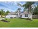 Beautifully landscaped yard with vibrant green grass and mature palm trees, enhancing curb appeal at 705 Sunburst Cove Ln, Winter Garden, FL 34787