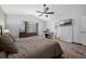 Comfortable main bedroom features a ceiling fan, desk, dresser, and an ensuite bathroom at 705 Sunburst Cove Ln, Winter Garden, FL 34787