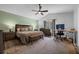 Spacious main bedroom with ceiling fan, a desk area, and wood-look floors at 705 Sunburst Cove Ln, Winter Garden, FL 34787