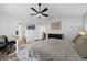Comfortable main bedroom features a ceiling fan, desk, dresser, and a closet at 705 Sunburst Cove Ln, Winter Garden, FL 34787