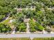 Aerial view showcases property boundaries, the home's position, and surrounding lush green neighborhood at 710 N Sparkman Ave, Orange City, FL 32763