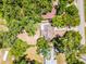 Aerial view of a single-Gathering home surrounded by trees and other houses, highlighting the neighborhood's layout at 710 N Sparkman Ave, Orange City, FL 32763