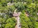 Overhead view of the house and its location amidst a lush green, tree-filled neighborhood at 710 N Sparkman Ave, Orange City, FL 32763