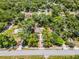 Aerial view showcases property boundaries, the home's position, and surrounding lush green neighborhood at 710 N Sparkman Ave, Orange City, FL 32763