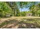 Large, shady backyard with mature trees and a shed, providing ample space and storage at 710 N Sparkman Ave, Orange City, FL 32763