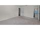 Neutral bedroom featuring an ensuite bathroom and neutral carpet at 710 N Sparkman Ave, Orange City, FL 32763