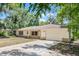 Charming one-story home with light exterior, attached garage, well-maintained landscaping, and inviting curb appeal at 710 N Sparkman Ave, Orange City, FL 32763