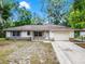 Lovely one-story home with neutral exterior, an attached garage, and mature trees, offering a peaceful retreat at 710 N Sparkman Ave, Orange City, FL 32763