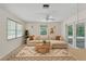 Bright living room with a comfortable sofa, stylish rug, and ample natural light at 710 N Sparkman Ave, Orange City, FL 32763