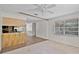 Spacious living area featuring tiled floors and an adjacent open kitchen concept at 710 N Sparkman Ave, Orange City, FL 32763