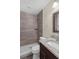 Chic bathroom with granite vanity, wood-style tile shower, and neutral color scheme at 7612 Pomelo Dr, Orlando, FL 32819