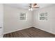 Cozy bedroom with wood floors and a ceiling fan for added comfort at 7612 Pomelo Dr, Orlando, FL 32819