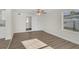 Comfortable bedroom with laminate wood floors, closet, ceiling fan, and bright natural light at 7612 Pomelo Dr, Orlando, FL 32819