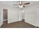 Bedroom with wood floors, ceiling fan, and access to en-suite bathroom at 7612 Pomelo Dr, Orlando, FL 32819