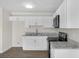 Modern kitchen with white cabinets, stainless steel appliances, and granite countertops at 7612 Pomelo Dr, Orlando, FL 32819