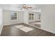 Spacious and open living area with ceiling fan, wood-look floors, and plenty of natural light at 7612 Pomelo Dr, Orlando, FL 32819