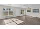 Light-filled living room featuring wood laminate flooring, ample windows, and ceiling fan at 7612 Pomelo Dr, Orlando, FL 32819