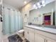 Inviting bathroom features a shower with curtain, modern vanity, and tile floor at 8030 John Hancock Dr, Winter Garden, FL 34787