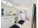Bright bathroom with double sinks, modern fixtures, and a glass-enclosed shower at 8030 John Hancock Dr, Winter Garden, FL 34787
