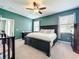 Spacious bedroom features a ceiling fan, plush carpeting, and abundant natural light from the window at 8030 John Hancock Dr, Winter Garden, FL 34787