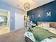 Well-lit bedroom with wainscotting, carpet, closet, and themed decor at 8030 John Hancock Dr, Winter Garden, FL 34787