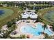 Aerial view of community pool and clubhouse with tropical landscaping and recreation areas at 8030 John Hancock Dr, Winter Garden, FL 34787