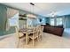 Dining area featuring a dining table with seating and modern lighting, next to the living room at 8030 John Hancock Dr, Winter Garden, FL 34787