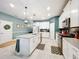 Bright kitchen with white cabinets, stainless appliances, island with sink and gray countertops at 8030 John Hancock Dr, Winter Garden, FL 34787