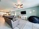 Open living area showcasing modern furnishings, a large sectional sofa, and views into the kitchen at 8030 John Hancock Dr, Winter Garden, FL 34787