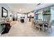 Open floor plan featuring kitchen, dining area, and living room with tile floors and neutral decor at 8030 John Hancock Dr, Winter Garden, FL 34787