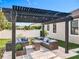 Charming outdoor patio with pergola, stylish seating, and a well-manicured yard at 8030 John Hancock Dr, Winter Garden, FL 34787