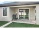Covered outdoor patio with grill and sliding glass doors leading to the home's interior at 8030 John Hancock Dr, Winter Garden, FL 34787