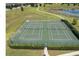 View of community tennis courts, green surface, surrounded by green space, and pond in the background at 8030 John Hancock Dr, Winter Garden, FL 34787
