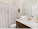 Well-lit bathroom with a vanity, mirror, and decorative shower curtain creating a relaxing space at 8982 Cabot Cliffs Dr, Davenport, FL 33896