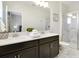 Bright bathroom with double vanity, modern fixtures, and a glass-enclosed shower at 8982 Cabot Cliffs Dr, Davenport, FL 33896