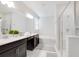 Bright bathroom with dual sinks, a soaking tub, and a spacious glass-enclosed shower at 8982 Cabot Cliffs Dr, Davenport, FL 33896