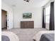 Neutral guest bedroom with a dresser and mounted television at 8982 Cabot Cliffs Dr, Davenport, FL 33896