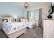 Stylish bedroom with two beds, lamps, and coastal decor with lots of natural light at 8982 Cabot Cliffs Dr, Davenport, FL 33896